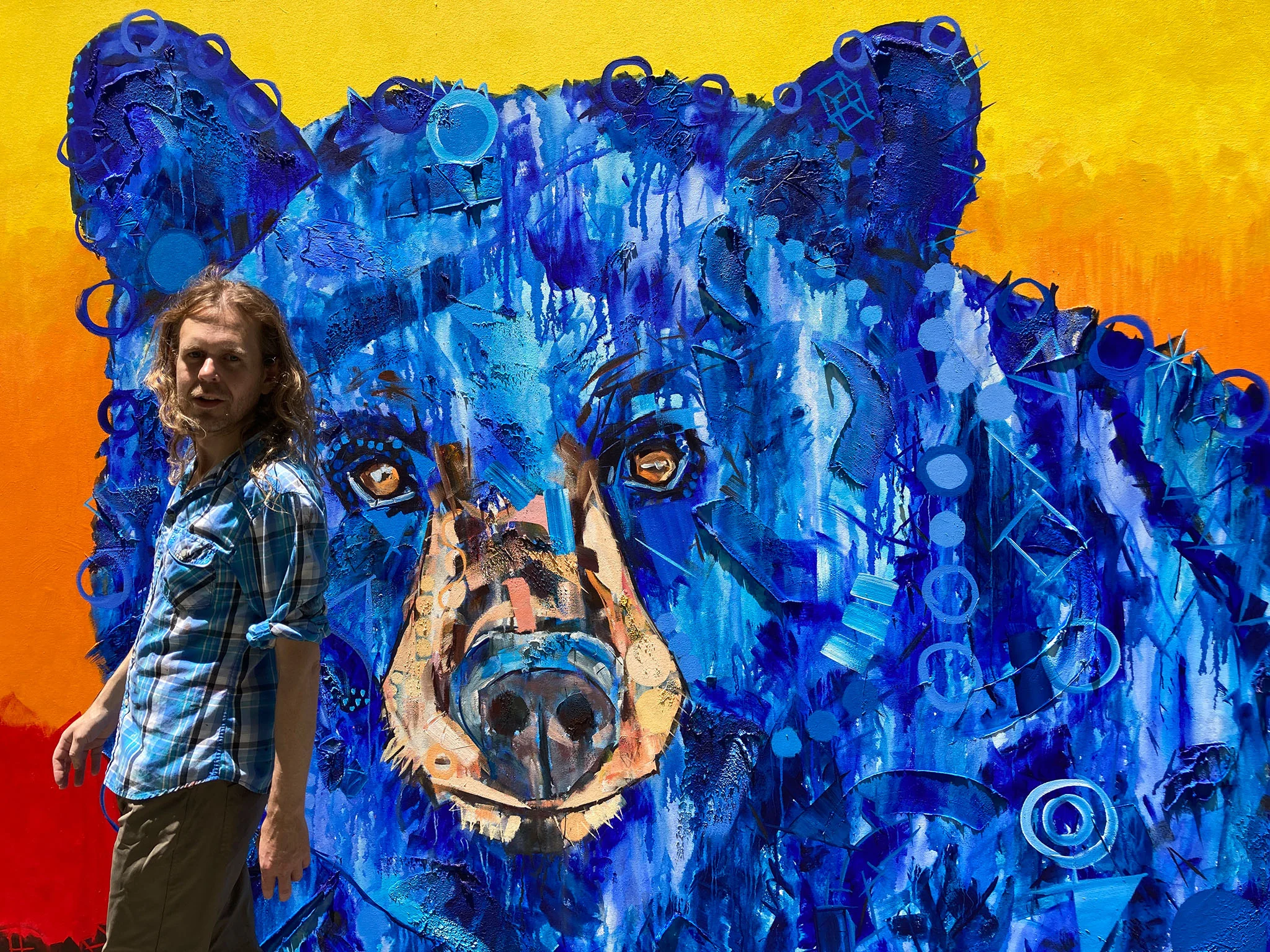 Artist Kent Paulette with his large bear painting that hangs at GFM.