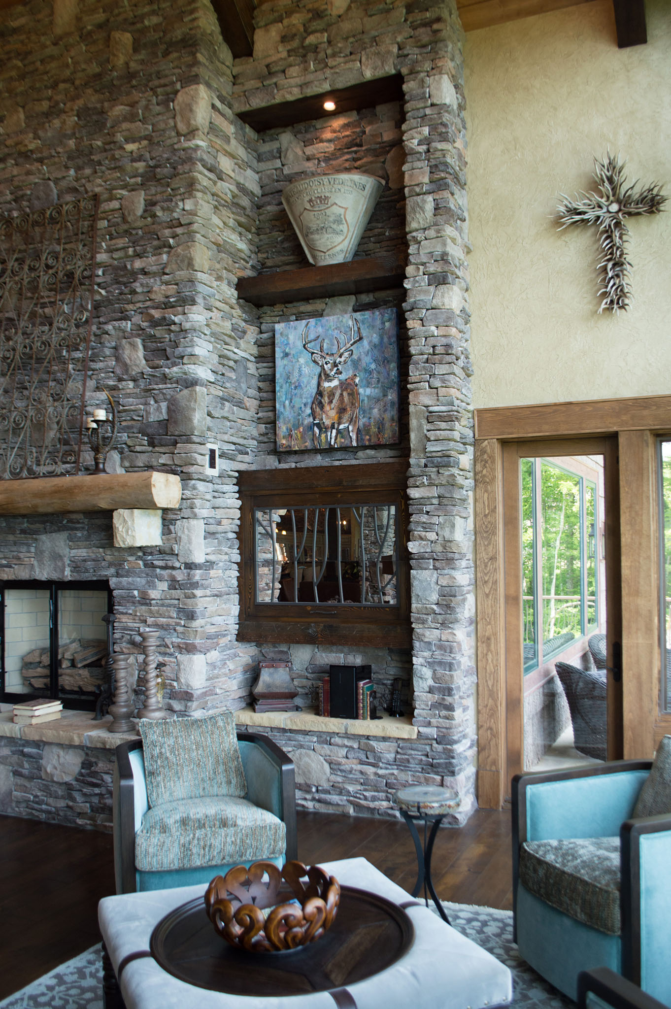 Interior design in a Banner Elk home with artwork over the fireplace. The home is at Linville Ridge and the designer is Kathleen McNamara